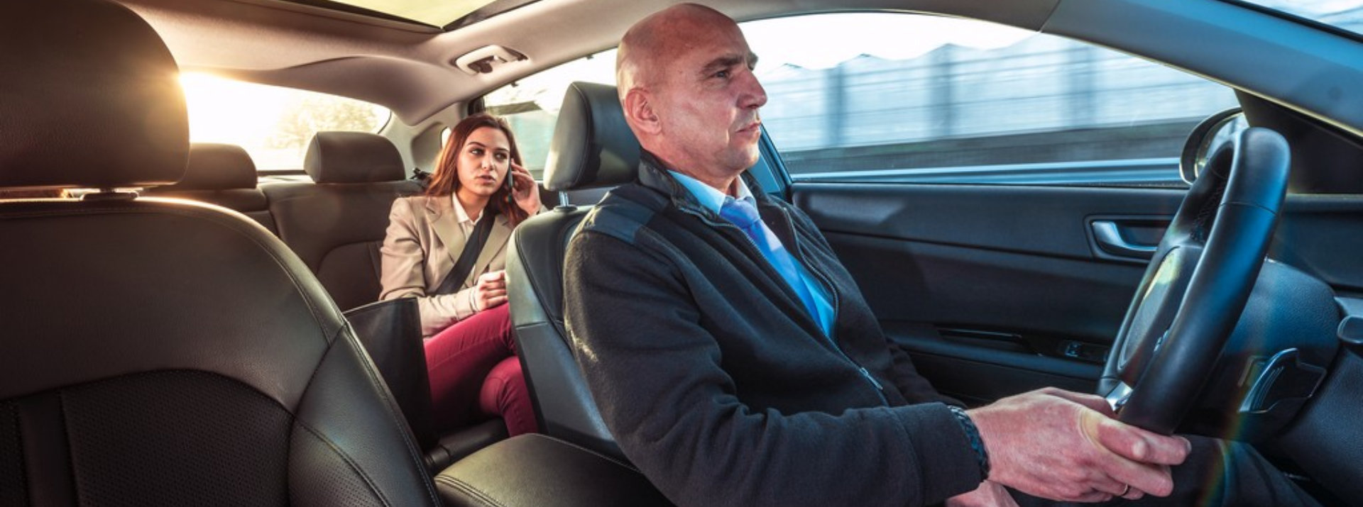 driver with her passenger inside a car